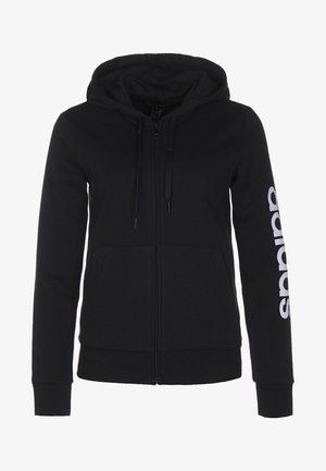 Sweat à capuche noir zippé en tissu doux, doté d'une capuche avec cordon de serrage, de poches avant et d'un texte logo blanc le long de la manche droite.