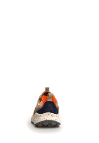 Zapatilla deportiva con parte superior de ante en color marrón, acentos en naranja, detalles en azul marino y una entresuela blanca moteada con un patrón de suela gris rugosa.