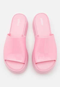 Infradito rosa con effetto lucido e superficie liscia. Presentano una fascia ampia sulla parte superiore e una suola a piattaforma spessa. Design minimalista.