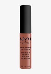NYX Soft Matte Lip Cream w przezroczystej tubie z czarną nakrętką, z matowym brzoskwiniowym kolorem, gładką teksturą i eleganckim cylindrycznym kształtem.