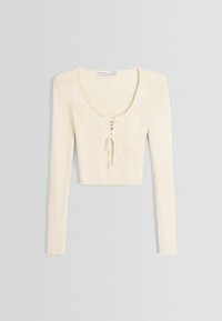 Krämfärgad ribbad långärmad crop-top med rundad halsringning och snörningsdetalj fram, med ett strukturerat tyg och figurnära design.