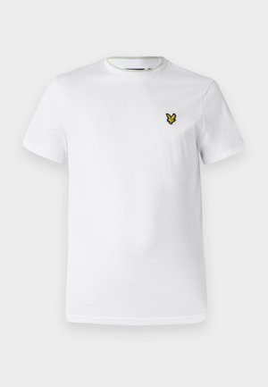 Vit bomullst-shirt med kort ärm, rund halsringning och en liten gul broderad logotyp på vänster bröst. Slät textur.