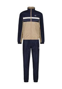 Tuta navy e beige con giacca con zip caratterizzata da strisce orizzontali bianche e pantaloni coordinati. Realizzato in materiale liscio e leggero.