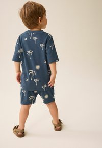 Next CHARACTER SET REGULAR FIT - Tracksuit bottoms - navy blue palms