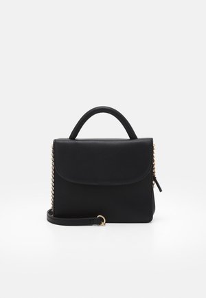 Black leather handbag with top handle, flap closure, gold chain side accents, and detachable shoulder strap on a white background.
