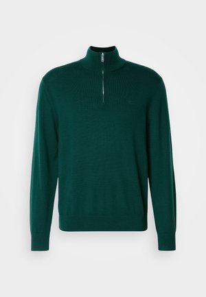 Temno zelena zip-up jopica z visokim ovratnikom, dolgimi rokavi in rebrastimi manšeti. Narejena iz gladkega, lahkega pletenega materiala. Diskreten detajl z logotipom.