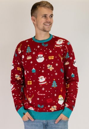 Roter Feiertagspullover mit festlichen Mustern von Schneemännern, dem Weihnachtsmann, Weihnachtsbäumen und Geschenken. Kontrastierender türkisfarbener Kragen und Bündchen.