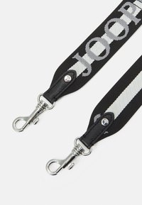 Black woven strap featuring silver hardware, leather ends, and "JOOP!" logo pattern. Includes two metal clips for attachment.