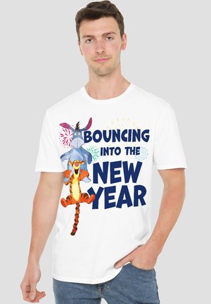 White cotton t-shirt featuring cartoon characters Eeyore and Tigger with blue text "BOUNCING INTO THE NEW YEAR" and colorful accents.