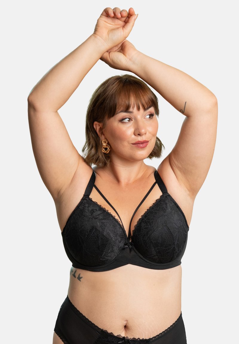 Black lace bra with molded cups, featuring a scalloped edge and decorative straps. Smooth texture with intricate patterns and a central bow detail.