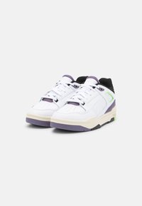 White sneaker with purple, green, and black accents. Soft leather upper with perforations, padded collar, and rubber outsole. Modern design.