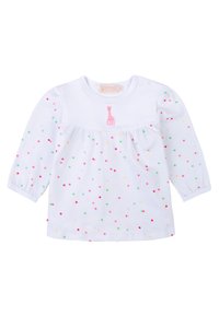 Maglietta bianca a maniche lunghe con scollo rotondo, vita arricciata e pois multicolori. Giraffa rosa ricamata vicino al colletto.