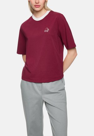 Maroon short-sleeve T-shirt with white ribbed collar, featuring a small cherry graphic on the chest. Soft, lightweight cotton fabric.