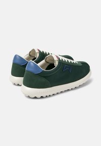 Green suede sneakers with blue accents, cream laces, and a textured rubber sole. Features a logo stitched on the side.