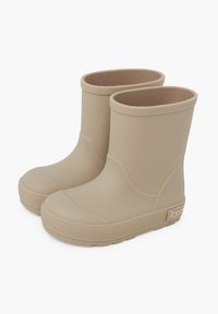 Bottes de pluie en caoutchouc beiges avec un extérieur lisse, un bout rond et une semelle texturée. Conçues avec un haut coupé bas et un branding subtil sur le côté.