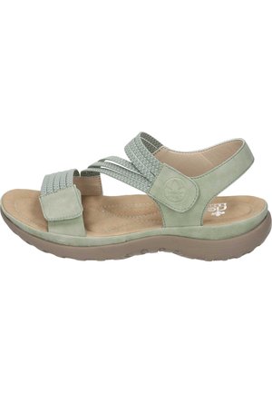 Green suede sandals with adjustable woven straps, beige footbed, lightweight sole, and textured detailing on the straps.