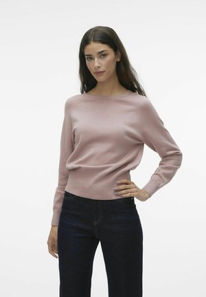 Light pink sweater with a round neckline and long sleeves, featuring a fitted waist and soft knit texture, paired with dark blue jeans.