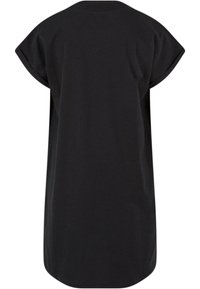 Schwarzes, oversized T-Shirt-Kleid mit kurzen, aufgerollten Ärmeln. Glatter Baumwollstoff, abgerundeter Saum und minimalistisches Design ohne sichtbare Logos oder Muster.