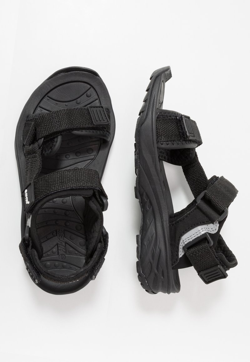 Black sandals with adjustable straps, rubber soles, and a textured interior. Features durable materials and a sporty design.