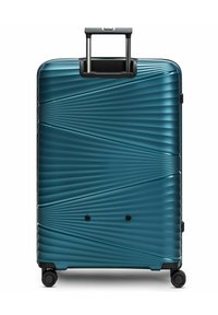 Valise rigide en teal avec un motif rayé texturé en diagonale, dotée d'une poignée télescopique et de quatre roues noires.