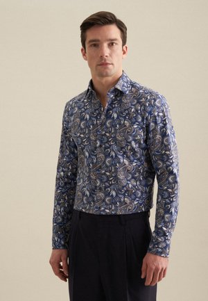 Long-sleeve shirt in blue, featuring a paisley pattern in cream and tan. Made of a smooth fabric with a button-down collar and fitted design.