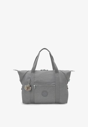 Sac de sport gris en nylon doux. Il possède des poignées jumelées, une poche frontale zippée et un charme décoratif en porte-clés.