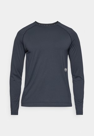 Koszula z długim rękawem w ciemnoszarym kolorze, wykonana z lekkiego materiału. Posiada rękawy raglanowe oraz subtelne logo na dolnym prawym boku. Gładka tekstura.