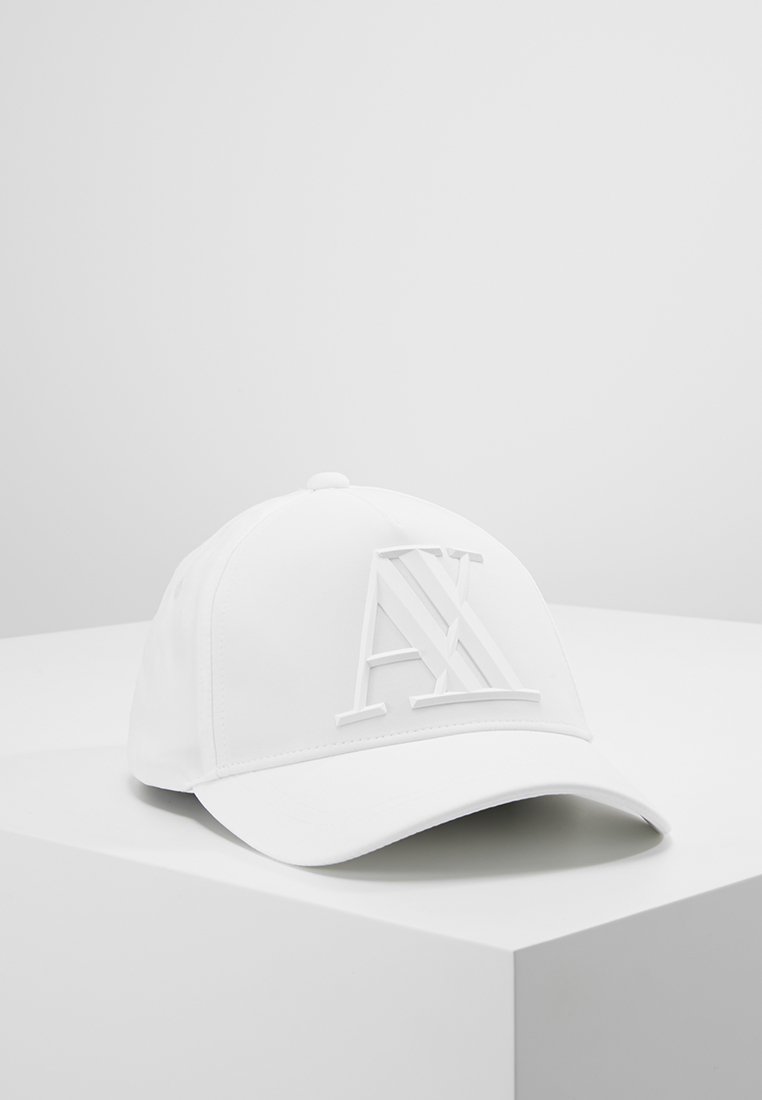 Cappellino da baseball bianco con un logo tridimensionale "AX" sul davanti. Realizzato in materiale liscio, con visiera curva e fascetta regolabile.