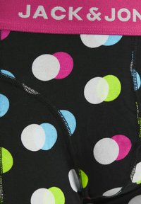 Black boxer briefs featuring a pink waistband with "JACK & JONES" text. The fabric has a polka dot pattern in white, blue, pink, and green.