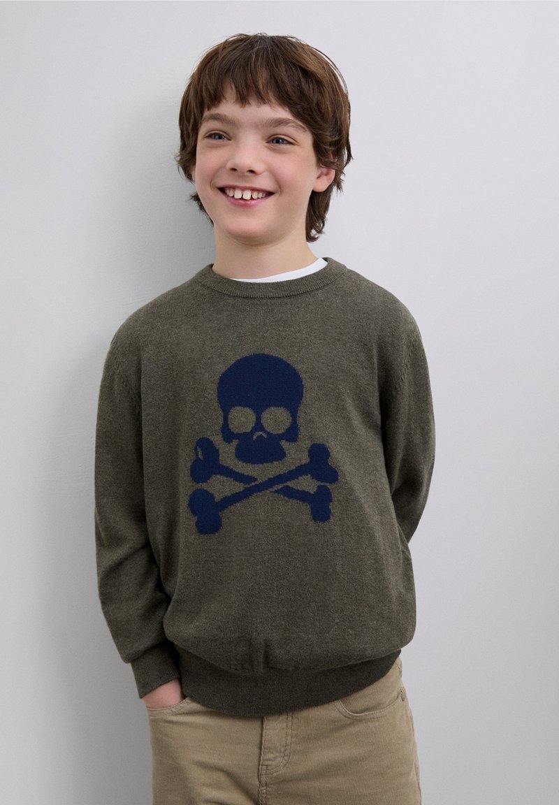 Olive green sweater featuring a large navy blue skull and crossbones design on the front, round neck, and ribbed cuffs and hem.
