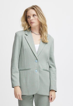 Light green checkered blazer with two blue buttons, notched lapels, and front pockets, made of textured fabric. Tailored fit.