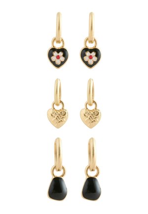 Three pairs of gold hoop earrings with heart-shaped charms: black with white flower and red center, engraved gold, and solid black stone.