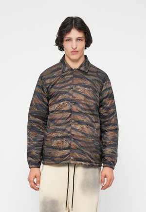 Quilted puffer jacket in brown and black camo pattern, with a collar, button front closure, and elasticized cuffs. Lightweight fabric.