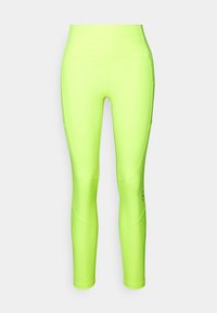 Neon green leggings made of stretchy fabric, featuring a high waistband and tapered design with seam detailing and a small logo.