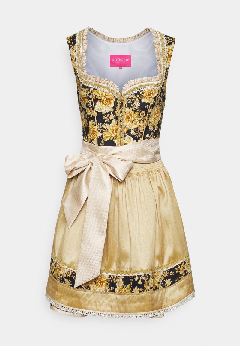 Robe dirndl traditionnelle sans manches avec corsage floral noir et doré, tablier beige noué d'un grand nœud et bordure de jupe assortie.