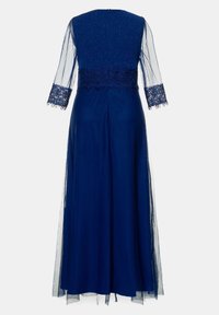 Navy blue dress with a fitted bodice featuring embellished lace and sheer sleeves. The skirt flows down to a full length and has a smooth texture.