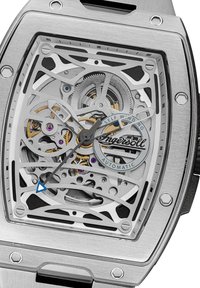 Rvs automatische horloge met een skeleton-design, blauwe accenten op de secondenwijzer, zichtbare tandwielen en paarse juwelen.