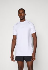 Weißes kurzärmliges Sportshirt mit Rundhalsausschnitt, das leichte graue Akzente an den Schultern und ein dezentes Logo auf der Brust aufweist.