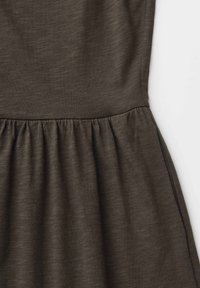 Dark olive green dress fabric with gathered waist seam and soft texture, shown on a white background.