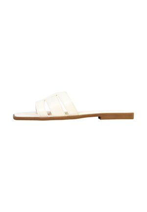 White flat slide sandal with tan sole and three wide straps across the top, shown from the side on a white background.