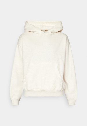 Felpa con cappuccio crema in morbido tessuto testurizzato. Presenta una tasca a marsupio, polsini e orlo a costine. Vestibilità rilassata con silhouette oversize.