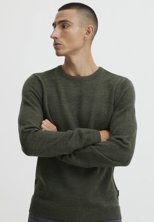 Dark green knit sweater, crew neckline, ribbed cuffs and hem, textured fabric, fitted silhouette, suitable for casual wear.