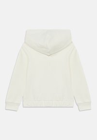 Φούτερ με κουκούλα σε εκρού χρώμα, με σούρες στο τελείωμα και απαλό ύφασμα. Λείο υφή με μακριά μανίκια και κουκούλα σε κανονική εφαρμογή.