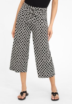 Black and white patterned wide-leg pants with a belt featured at the waist, made of lightweight fabric with a loose fit and cropped length.