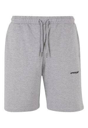 Graue Baumwollshorts mit einem elastischen Bund und Kordelzug. Mit kleinem schwarzen "UPSCALE"-Logo auf der Vorderseite. Glattes, leichtes Material.