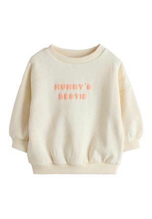 Sahnefarbener Kleinkind-Sweatshirt mit gerippten Bündchen und Saum, mit erhabenen pinkfarbenen Schriftzug "MUMMY'S BESTIE" auf der Brust.