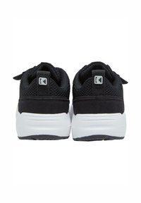 Baskets noires de sport avec un dessus en maille texturée, des accents en daim et une semelle intermédiaire blanche. Comprend une étiquette de logo au talon et une semelle extérieure en caoutchouc.