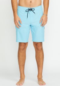 Shorts de bain bleu clair en tissu à séchage rapide, dotés d'un cordon de serrage noir, de poches latérales et d'une coupe confortable et ample.