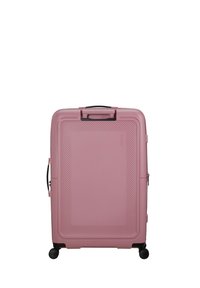 Valigia rigida rosa con un motivo diagonale testurizzato, maniglia laterale e quattro ruote nere per la mobilità. Dotata di una maniglia superiore per il trasporto.