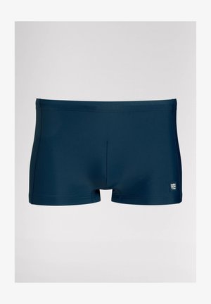 Donkerblauwe zwemboxers gemaakt van rekbare stof, met een gladde textuur, korte benen en een klein label aan de linkerkant.